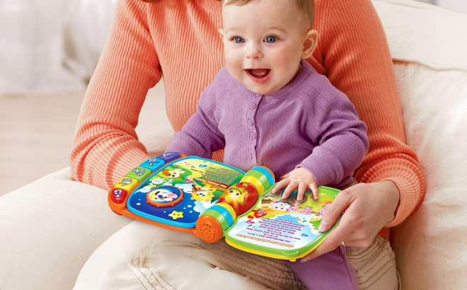 Baby Using VTech Musical Rhymes Book