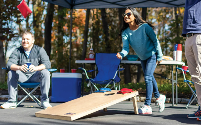 Family Enjoying the Cornhole Boards with Bean Bags at a Campsite