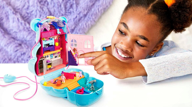 Girl Playing with Polly Pocket 2 In 1 Travel Toy