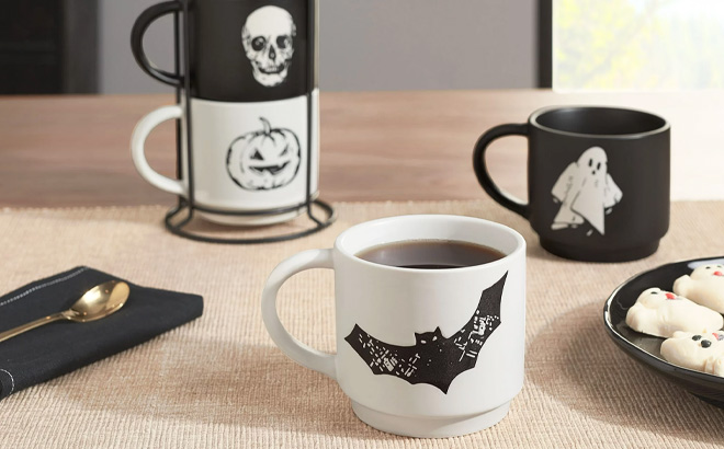 https://www.freestufffinder.com/wp-content/uploads/2023/09/Halloween-Black-and-White-Halloween-Icons-Glazed-Ceramic-Stacking-Mug-Set-with-Metal-Rack-on-the-Table.jpg