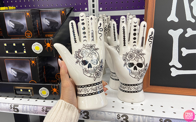 Hand Holding a Halloween Tattoo Palm Decoration 9 Inch in a Store Aisle