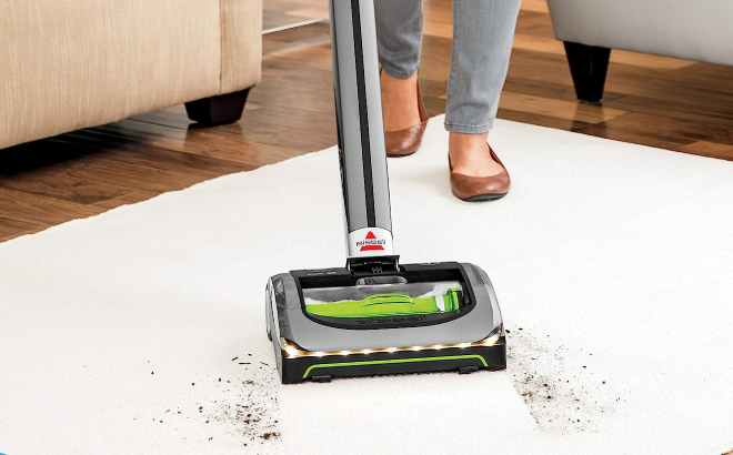 Lady Using Bissell AirRam Cordless Vacuum to Clean a Carpet