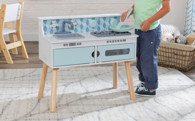 Little Boy Playing with KidKraft Play Put Away Wooden Tabletop Kitchen