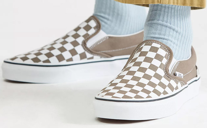 Man is Wearing Vans Classic Slip On Checkerboard Shoes in Walnut Color