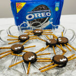 Oreo Spider Cookies in Glass Plate next to Bag of Oreos