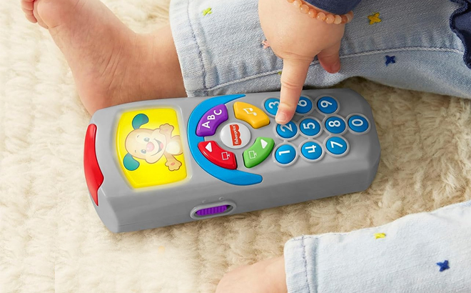 Toddler Playing with the Fisher Price Laugh and Learn Pretend TV Remote Control Toy