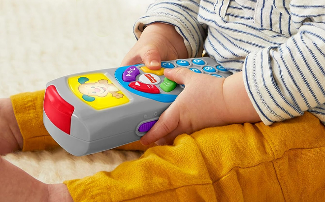 Toddler Playing with the Fisher Price Laugh and Learn TV Remote Control Toy