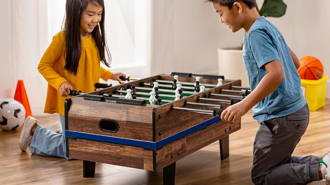 Two kids playing foosball on BCP 11 in 1 Combo Game Table Set