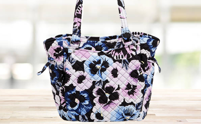 Vera Bradley Plum Pansies Glenna Satchel on a Table