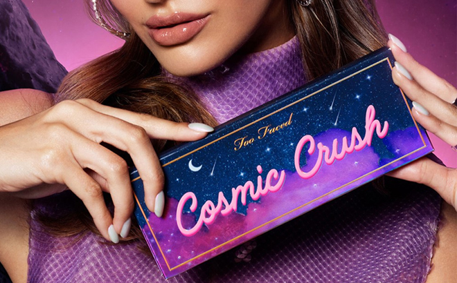 Woman Holding the Too Faced Cosmic Crush Eyeshadow Palette