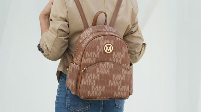 Woman Wearing MKF Palmer Vegan Leather Signature Logo print Womens Backpack