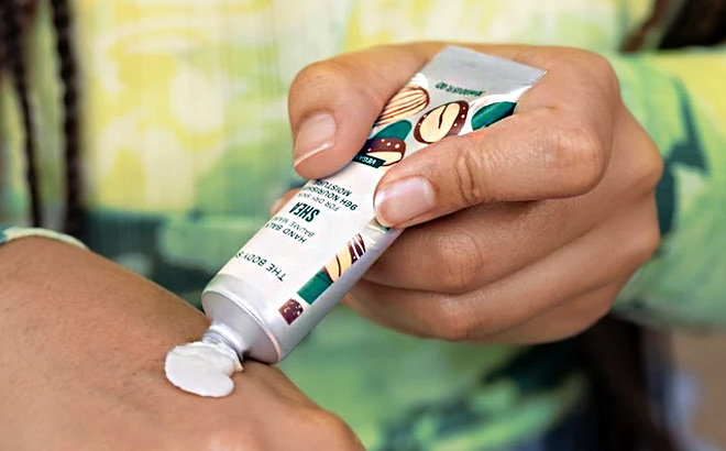 Woman is Holding The Body Shop Shea Hand Balm