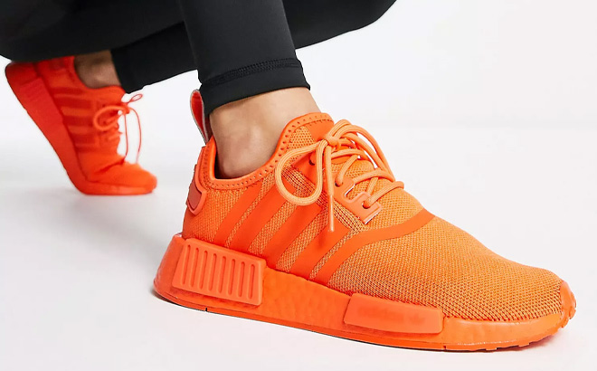 Woman is Wearing Adidas NMD R1 Shoes in Impact Orange Color