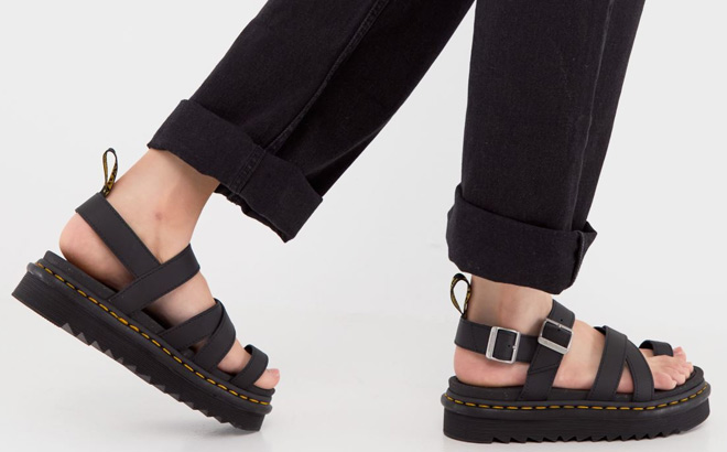 Woman is Wearing Dr Martens Avry Platform Sandals in Black Color