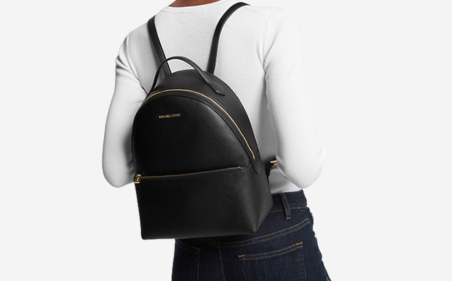 Woman is Wearing Michael Kors Sheila Medium Faux Saffiano Leather Backpack in Black Color