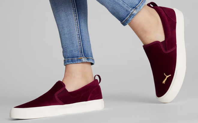 Woman is Wearing Puma Bari Slip On Comfort Velvet Shoes in Aubergine Color