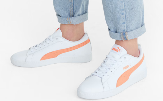 Woman is Wearing Puma Smash Leather Sneakers in Apricot Blush and White Colorr