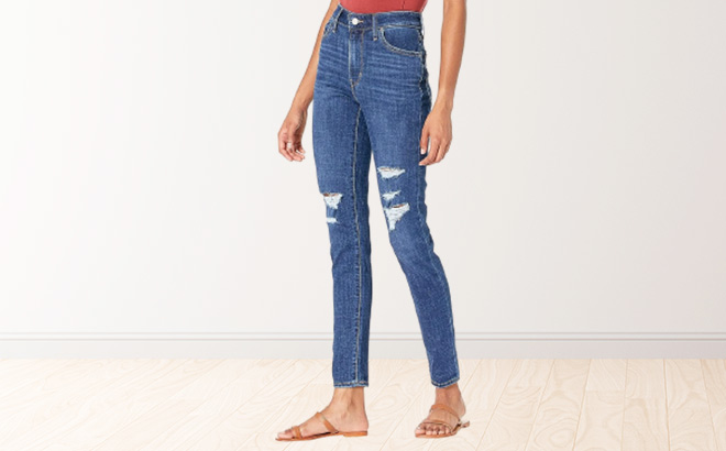 Woman is Wearing a Levis 721 High Rise Skinny Jeans in Lapis Longing Color