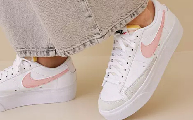 Woman is Wearing a Nike Blazer Low Platform Casual Shoes in White Pink Glaze and Summit White Color