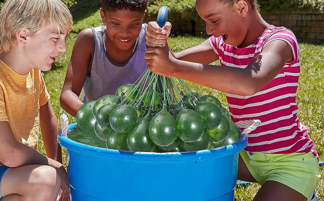 an Image of Three Kids Playing with a Bunch O Balloons 100 Grenade