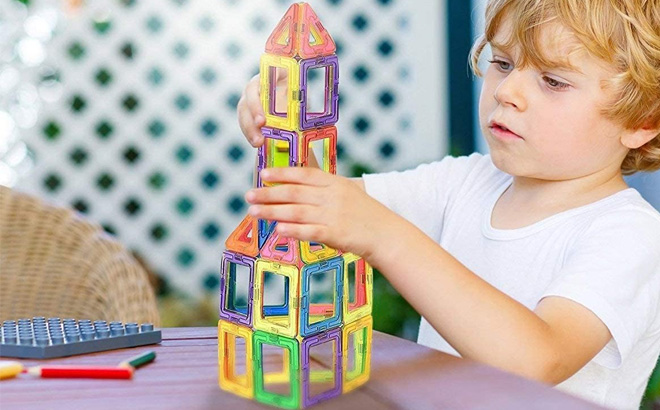 an Image of a Boy Playing with a Magnetic STEM Building Blocks