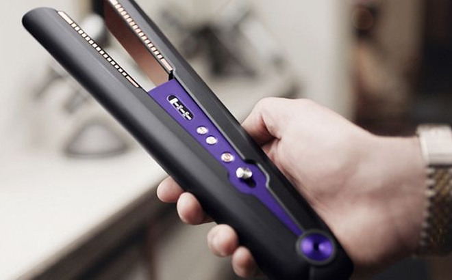 an Image of a Hand Holding a Dyson Corrale Hair Straightener Black Purple Color