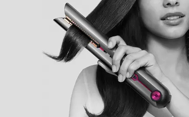 an Image of a Woman Using a Dyson Corrale Hair Straightener