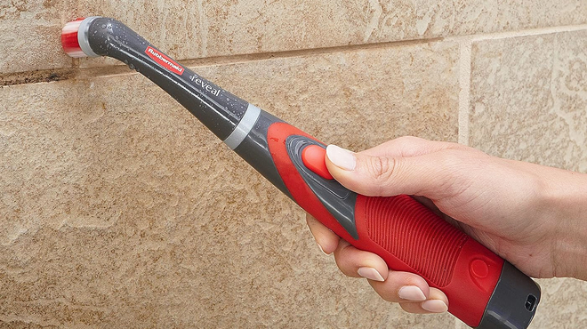 A Hand Holding Rubbermaid Reveal Cordless Battery Power Scrubber