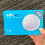 A Hand Holding the Echo Dot 5th Gen 2022 Release