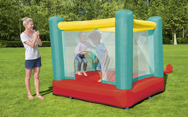 A Mother with Two Kids Playing with Play Day Jump and Soar Inflatable Bouncer