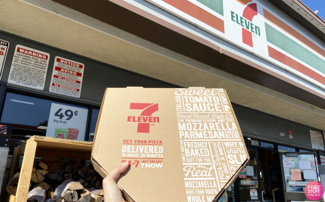 A Person Holding a Box of Pizza in front of 7 Eleven Store