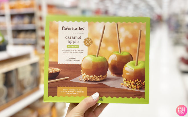 A Person Holding a Favorite Day Harvest Caramel Apple Dipping Kit