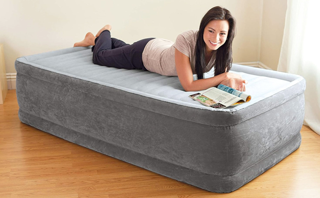 A Woman Laying Down on Intex Elevated Airbed Inside the Bedroom