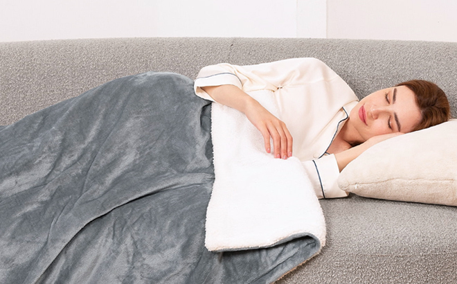 A Woman on a Couch Covered in Electric Heated Blanket 1