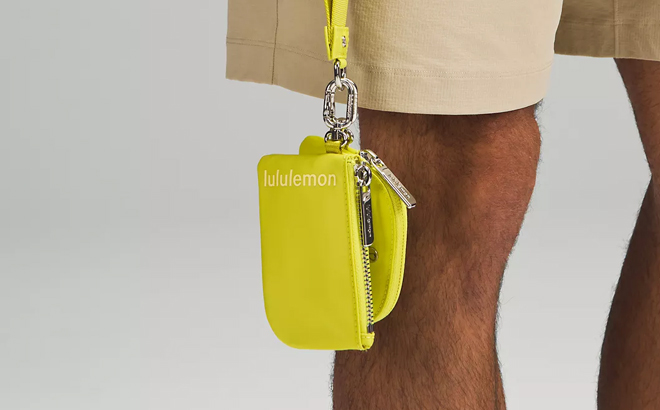 A person holding a Lululemon Dual Pouch Wristlet