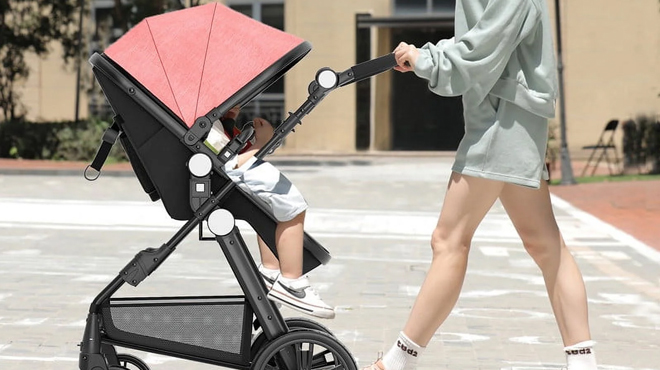 A person pushing a Cynebaby Foldable Baby Stroller