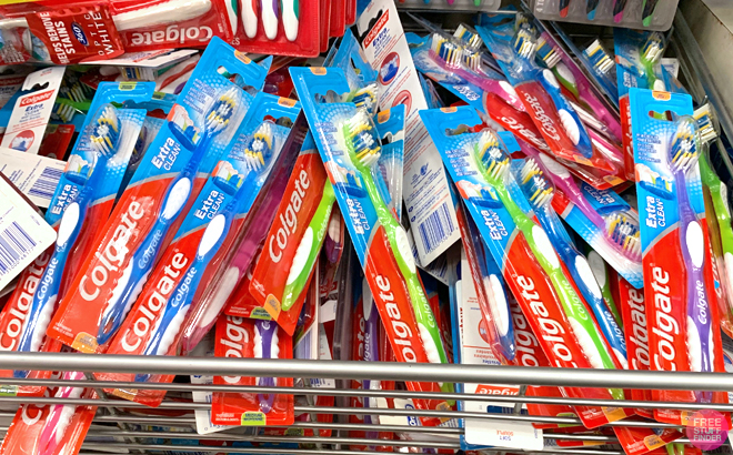 A pile of Colgate Extra Clean Toothbrush on the shelf