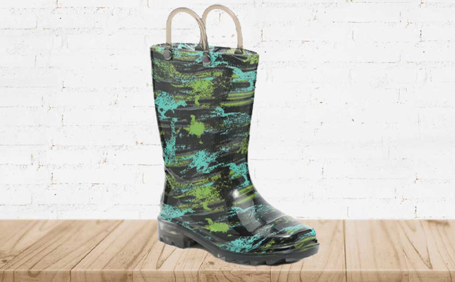 Dino Light Up Rain Kids Boots on a Wooden Floor