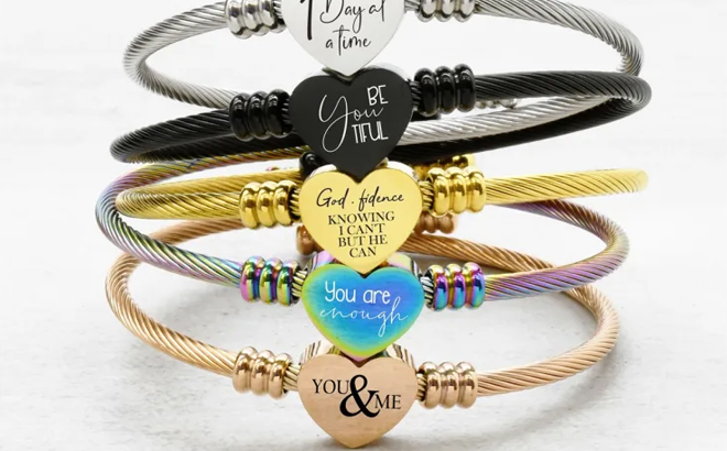 Five Reversible Inspirational Heart Bracelets Stacked on a Table