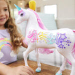 Girl is Playing with Barbie Dreamtopia Unicorn Toy