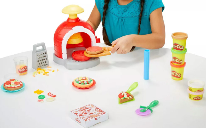 Girl is Playing with Play Doh Kitchen Creations Pizza Oven Playset