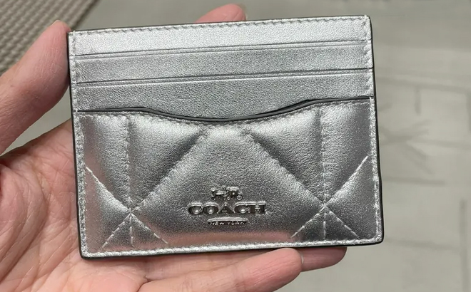 Hand Holding Coach Outlet Slim ID Card Case with Puffy Diamond Quilting