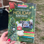 Hand Holding Costco Holiday Savings Black Friday Flyer