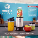 Hand Holding Magic Bullet Single Serve Blender in a Box