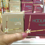 Hand Holding Two Benefit Cosmetics Hoola Matte Bronzers