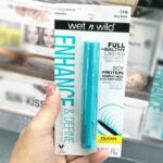 Hand holding Wet n Wild Enhance Megawear Mascara In a shop