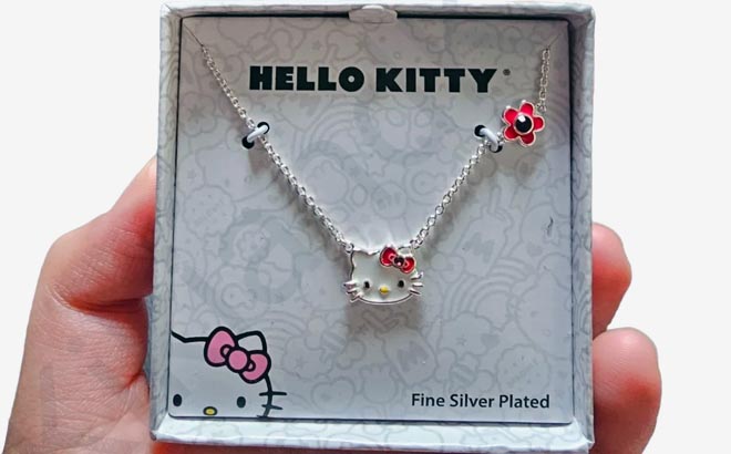 Hand holding one Hello Kitty Crystal Birthstone Necklace