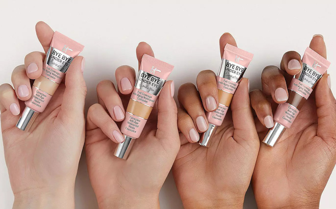 Hands Holding IT Cosmetics Bye Bye Undereye Illumination Full Coverage Anti Aging Waterproof Concealers