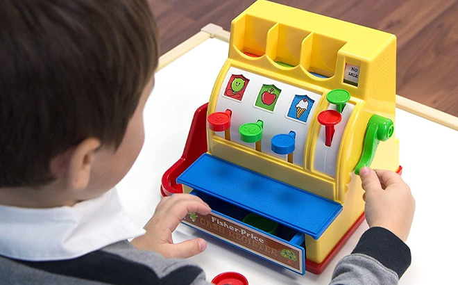 Kid Playing with Fisher Price Retro Cash Register Toy