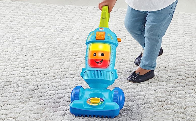 Kid Playing with Fisher Price Vacuum Toy